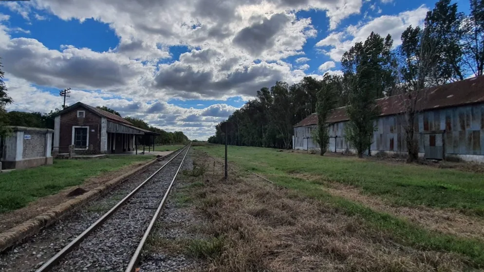 Fotografía de la estación de ferrocarril de Santa Coloma, rodeada de árboles y paisaje rural.